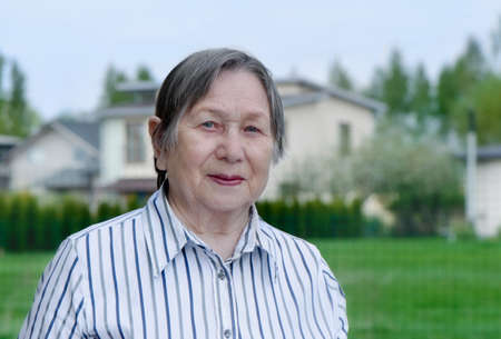 Happy senior woman outdoors in summer の写真素材