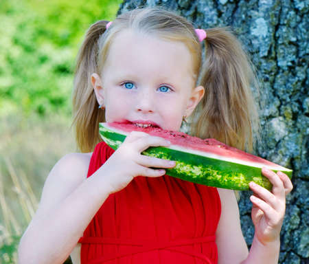 little girl eating watermelon の写真素材