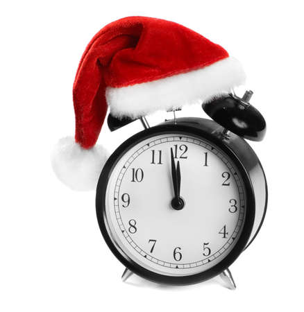 Alarm clock with Santa hat isolated on whiteの写真素材