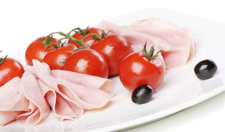 Slices of ham and tomatoesの写真素材