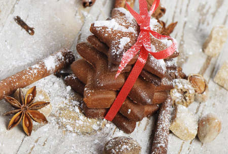 Christmas cookies and spices on a wooden tableの写真素材