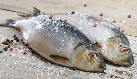 Two herrings on a wooden tableの写真素材