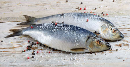 Two herrings on a wooden tableの写真素材