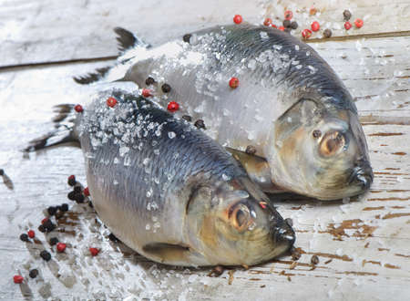 Two herrings on a wooden tableの写真素材