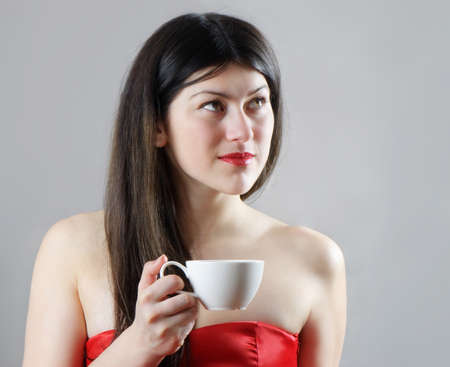 Beatiful young  woman drinking coffeeの写真素材