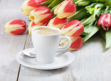 Coffee cup and red  tulipsの写真素材