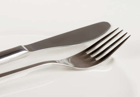 Knife and fork on a white plate