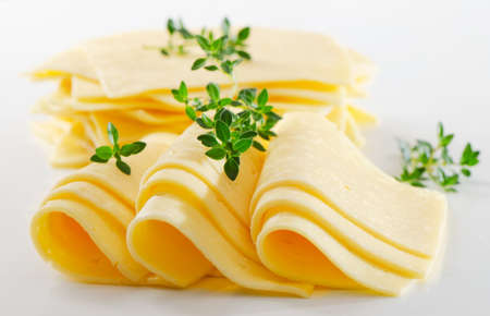 Cheese slices with fresh herbsの写真素材