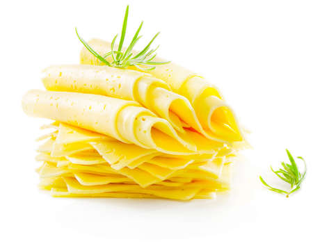 Cheese slices with fresh herbs isolated on whiteの写真素材