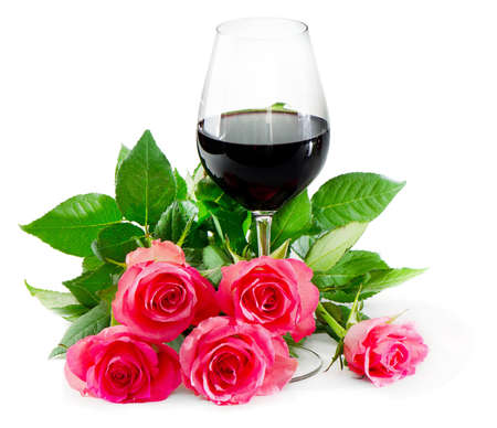 red wine in glass and pink rosesの写真素材