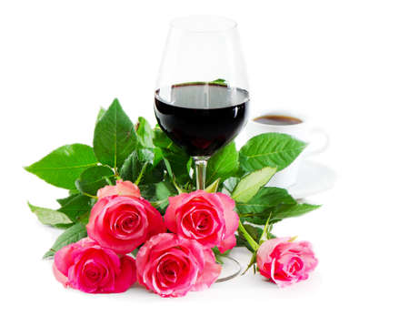 red wine in glass and pink rosesの写真素材