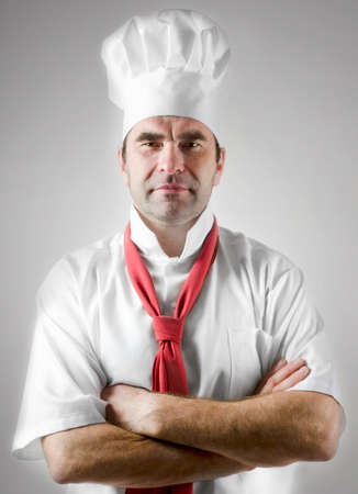Smiling chef in white uniformの写真素材