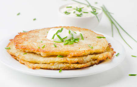Potato Pancake with Sour Cream and fresh herbsの写真素材