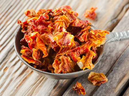 dried tomatoes on a wooden tableの写真素材