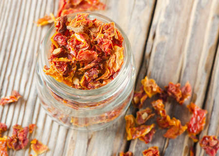 dried tomatoes on a wooden tableの写真素材