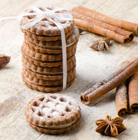 Cookies and spices on a wooden tableの写真素材