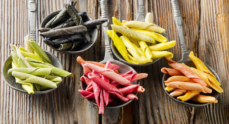 Italian pasta - uncooked multicolored macaroniの写真素材