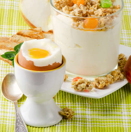 Healthy breakfast - boiled egg , yogurt with muesliの写真素材