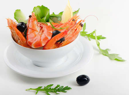 tiger shrimps with lemon and black olivesの写真素材