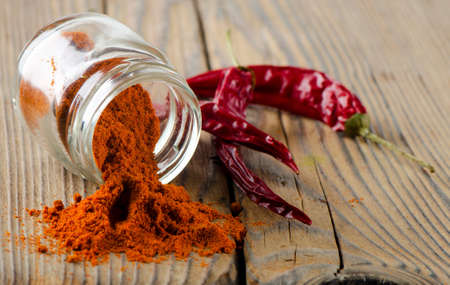 Red pepper spice on wooden tableの写真素材