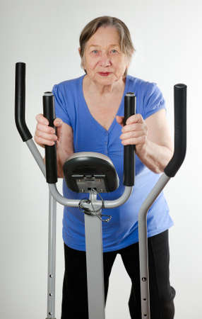Senior woman on stationary training bicycle