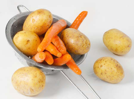 Vegetables in metal colanderの写真素材