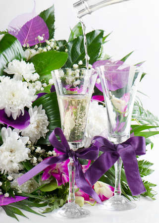beautiful fresh flowers bouquet and pouring champagneの写真素材
