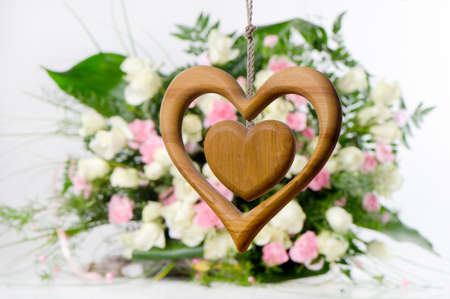 Wooden heart on flower backgroundの写真素材