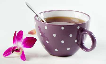 Cup of black tea and flowerの写真素材