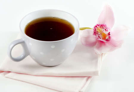 Cup of black tea and flowerの写真素材
