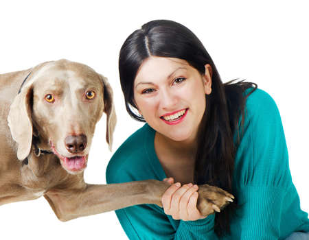 Young smiling woman with dog isolated on whiteの写真素材