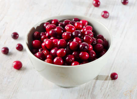 Cranberries on wooden tableの写真素材