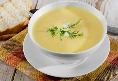 Creamy pumpkin soup on a wooden tableの写真素材