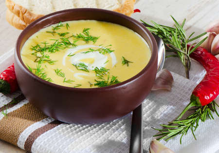 Creamy pumpkin soup on a wooden tableの写真素材
