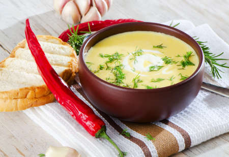 Creamy pumpkin soup on a wooden tableの写真素材