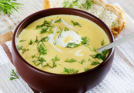 Creamy pumpkin soup on a wooden tableの写真素材