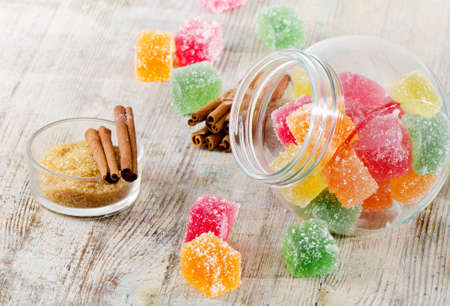 Colorful jelly candies on a wooden tableの写真素材