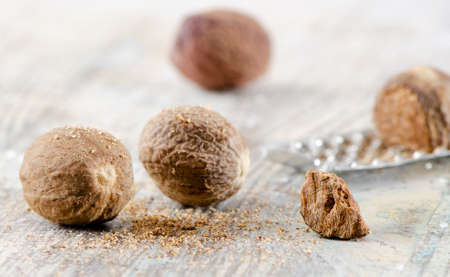 Nutmegs on a wooden table. Selective focus.の写真素材