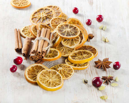 spices and dried oranges on a wooden tableの写真素材