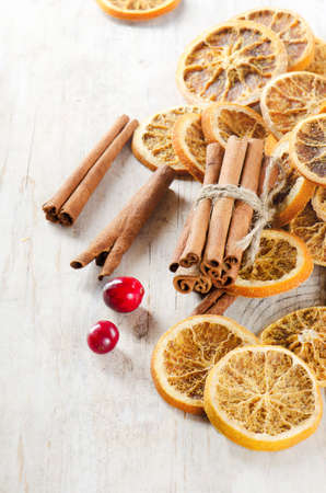 Cinnamons sticks and dried oranges on a wooden tableの写真素材