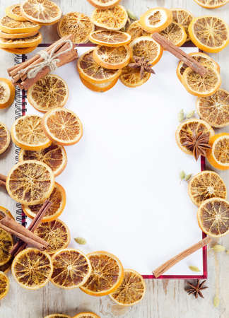 Empty book ready for recipes or menu and dried orangesの写真素材