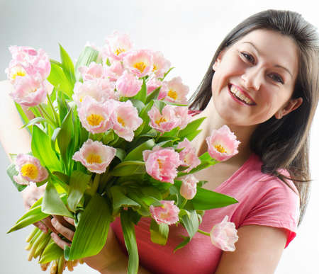 Beautiful happy woman with springs flowerの写真素材