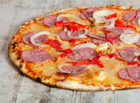 Pepperoni pizza on a wooden tableの写真素材