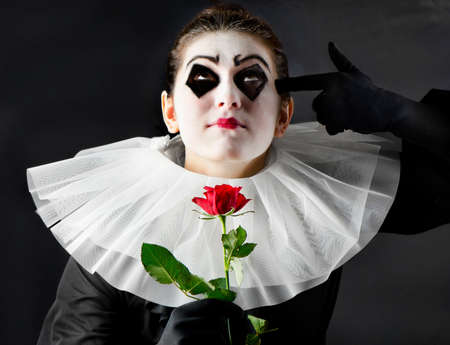 woman mime with red roseの写真素材