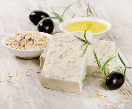 Homemade Soap with oat meal and olives  on a wooden tableの写真素材