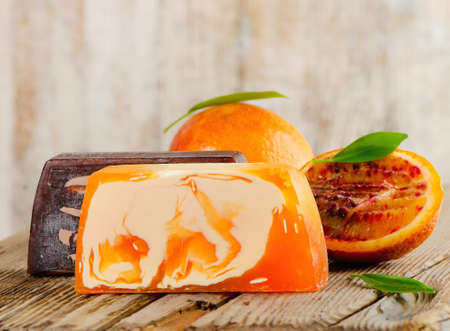 Homemade Soap with fresh orange   on a wooden table. Selective focusの写真素材