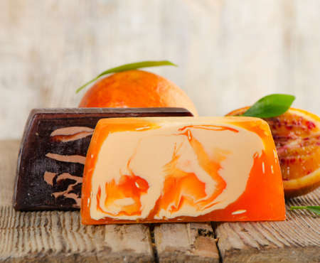 Homemade Soap with fresh orange   on a wooden table. Selective focusの写真素材