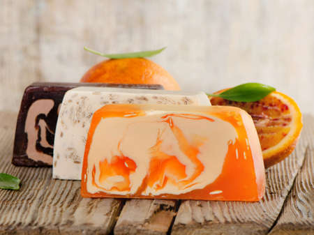 Homemade Soap with fresh orange   on a wooden table. Selective focusの写真素材