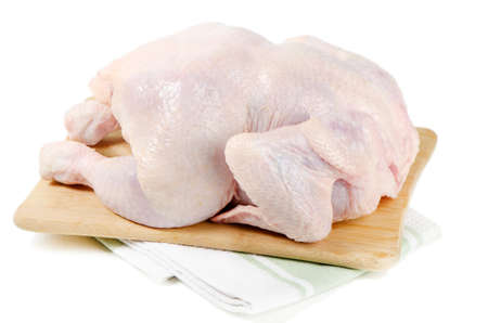Whole raw chicken isolated on whiteの写真素材