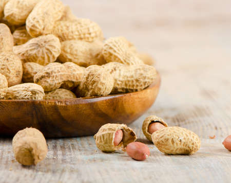 Peanuts on a wooden table.Selective focusの写真素材
